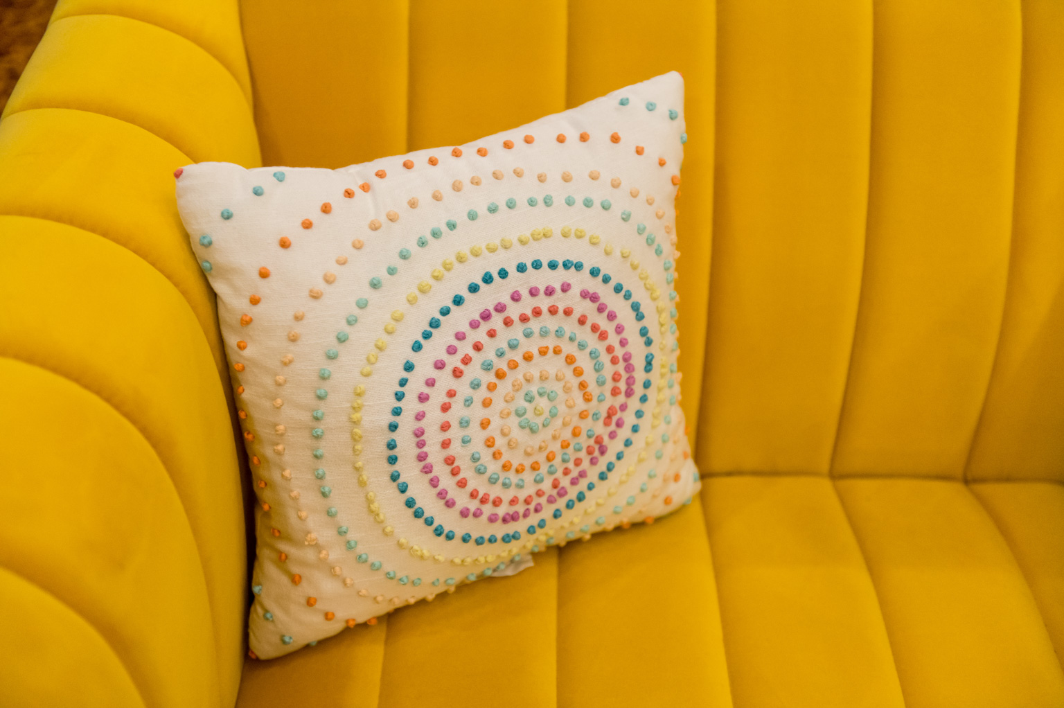 Pillow with rainbow texture on a couch, Product Photographers, Yellow Couch, Velvet Couch, Milwaukee Product Photographer, Pillow