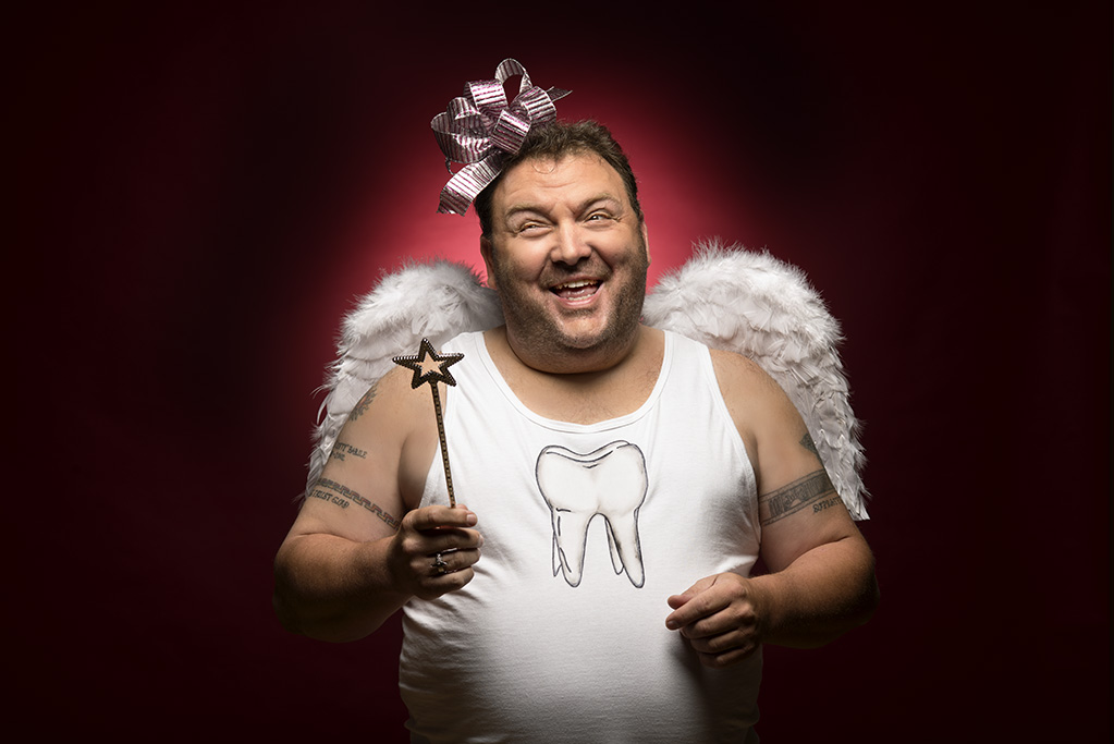 Manly tooth fairy with wings and wand captured for a halloween ad campaign
