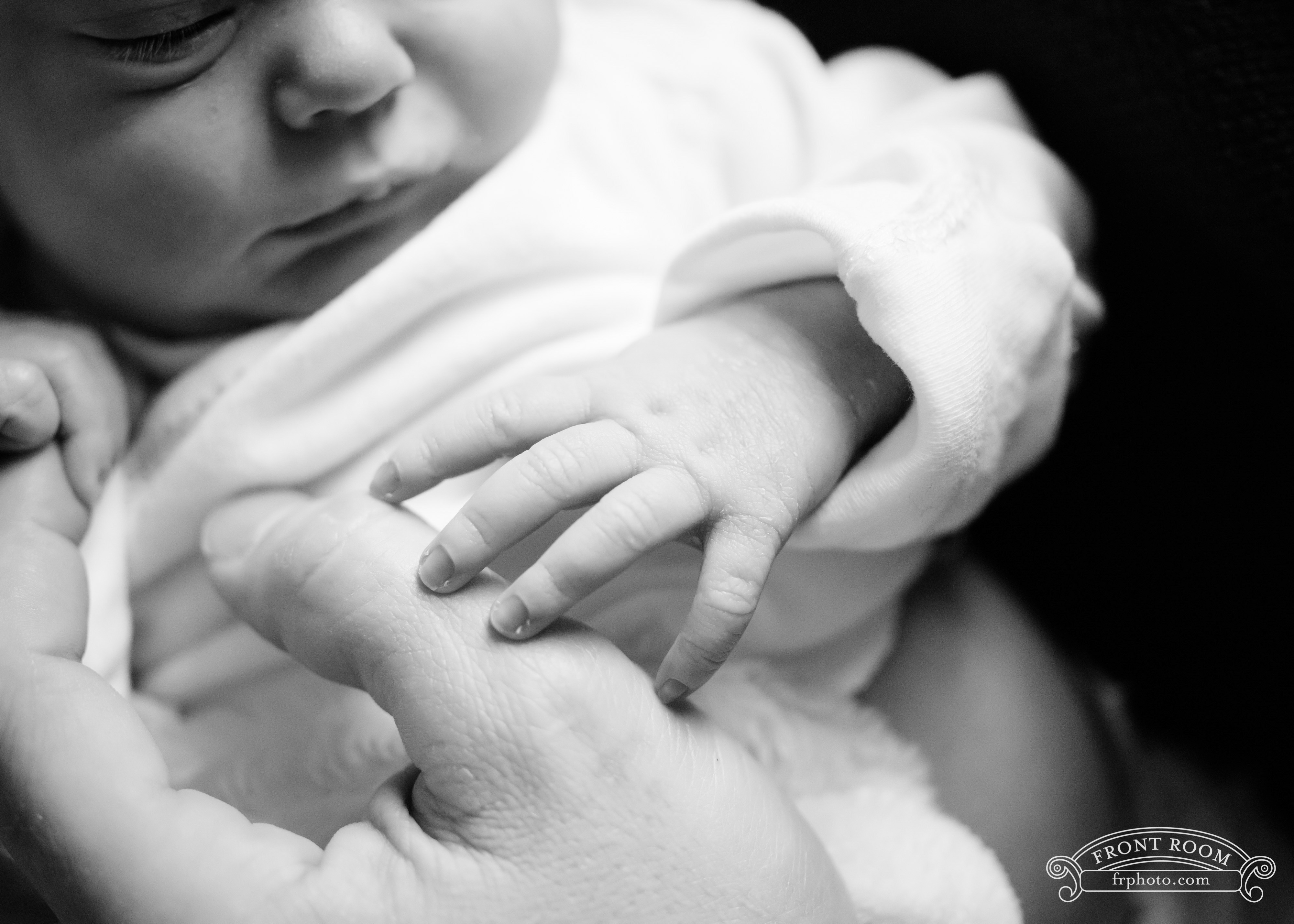 tiny newborn hands in black and white